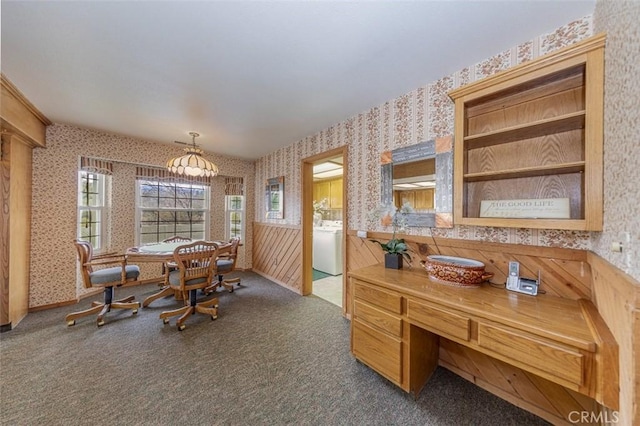 dining space featuring washer / clothes dryer and dark colored carpet