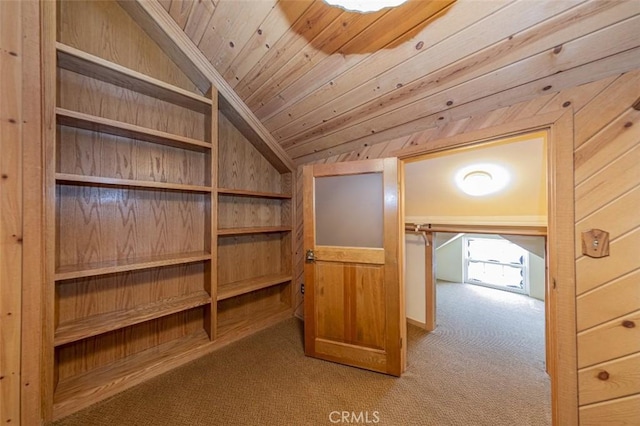 interior space with wooden walls, lofted ceiling, wooden ceiling, and light colored carpet