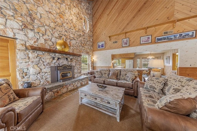 carpeted living room featuring a high ceiling and wooden walls