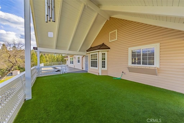 rear view of property featuring a lawn