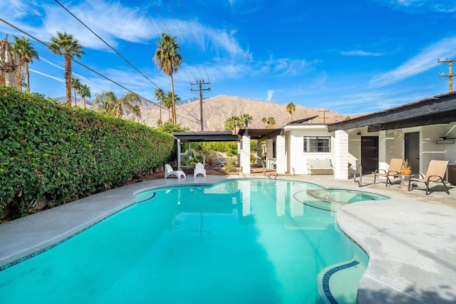 view of pool with a patio and a mountain view