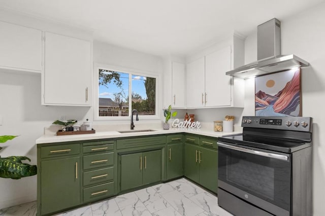 kitchen featuring wall chimney exhaust hood, sink, green cabinetry, stainless steel electric range oven, and white cabinets