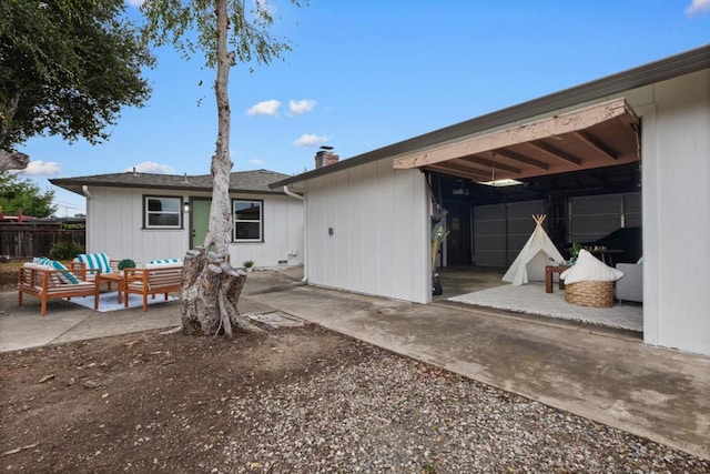 rear view of house with a patio area and outdoor lounge area