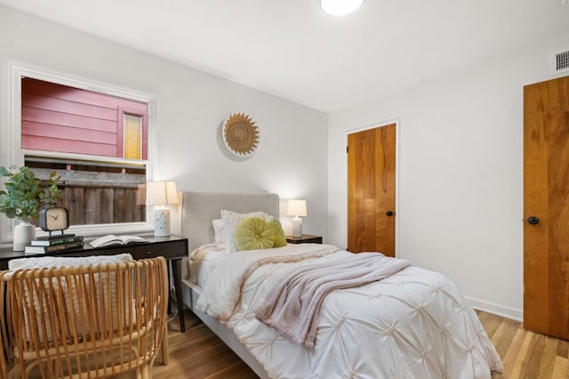 bedroom with hardwood / wood-style floors