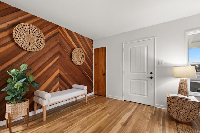 interior space with wooden walls and light wood-type flooring