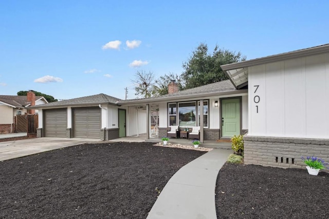 single story home featuring a porch and a garage