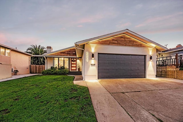 single story home with a garage and a lawn