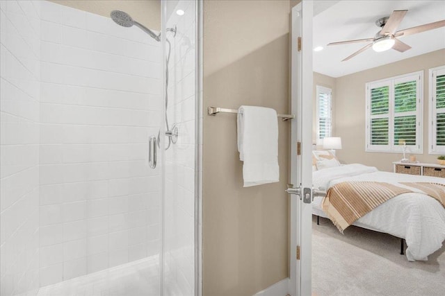 bathroom featuring a shower with door and ceiling fan