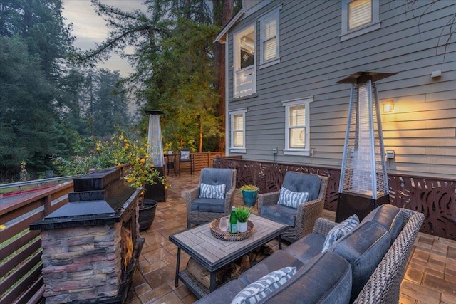 patio terrace at dusk featuring an outdoor living space