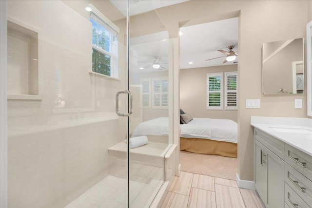 bathroom with a shower with door, vanity, plenty of natural light, and ceiling fan