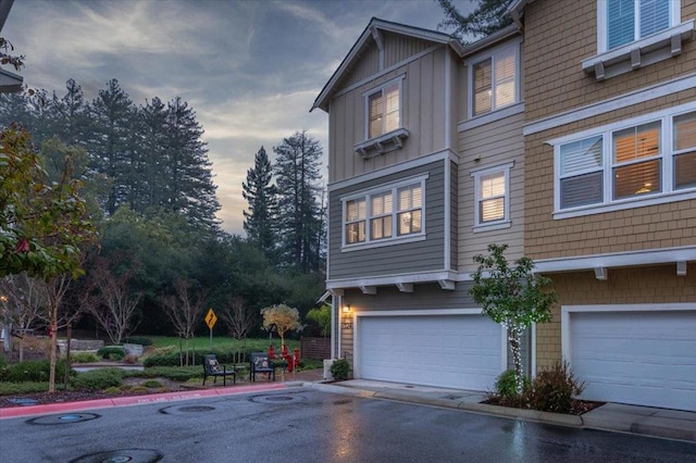 property exterior at dusk with a garage