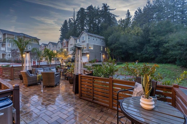 patio terrace at dusk featuring an outdoor hangout area