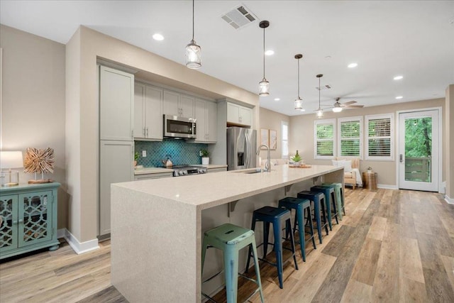 kitchen featuring stainless steel appliances, a large island, and pendant lighting