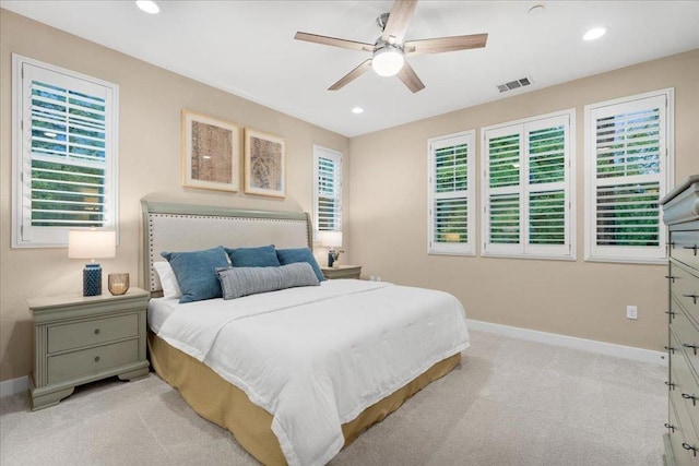 bedroom with ceiling fan and light carpet