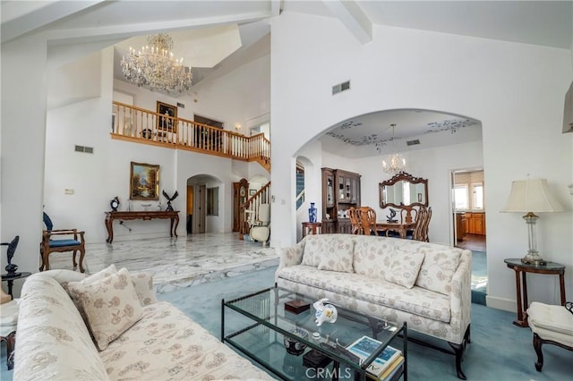 carpeted living room featuring beamed ceiling, high vaulted ceiling, and a chandelier