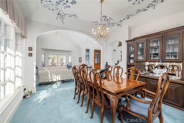 dining space with a chandelier and carpet