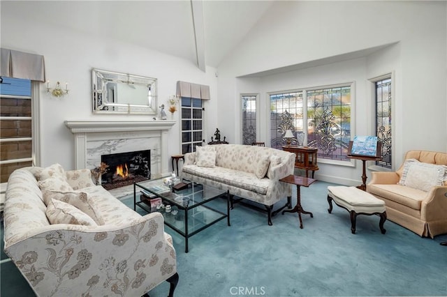 living room with carpet, high vaulted ceiling, and a high end fireplace