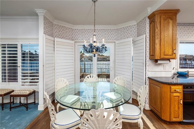 dining area with crown molding, dark hardwood / wood-style floors, and a notable chandelier