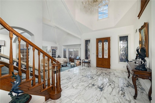 foyer with an inviting chandelier and a high ceiling