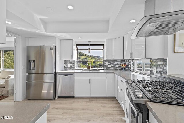 542 San Clemente Way, Camarillo, CA 93010 - kitchen with stainless steel appliances, exhaust hood, plenty of natural light, white cabinetry, and recessed lighting