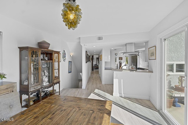 542 San Clemente Way, Camarillo, CA 93010 - corridor featuring light wood-style flooring and a chandelier