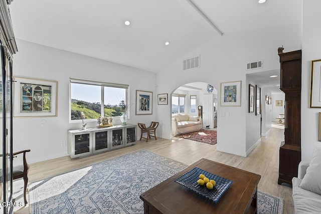542 San Clemente Way, Camarillo, CA 93010 - living area featuring arched walkways, beam ceiling, healthy amount of natural light, light wood-style floors, and high vaulted ceiling