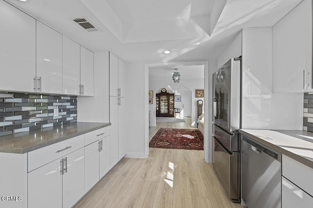 542 San Clemente Way, Camarillo, CA 93010 - kitchen with stainless steel appliances, arched walkways, white cabinets, tasteful backsplash, and recessed lighting