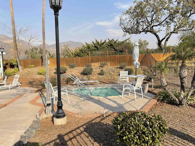 view of pool with a patio and a mountain view