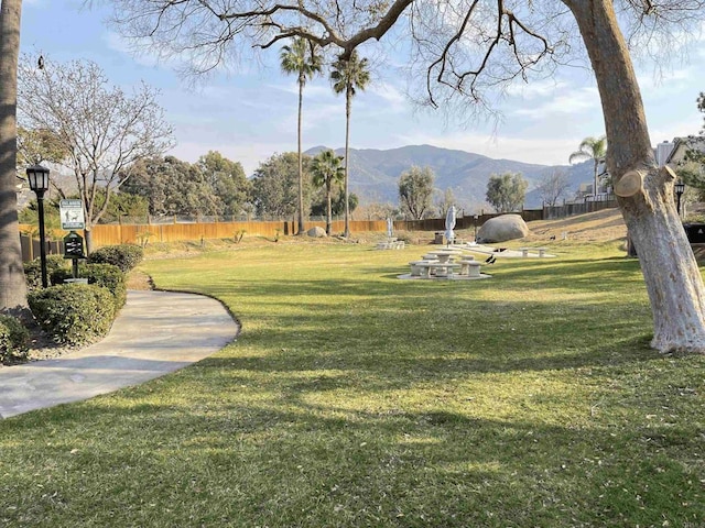 view of community with a mountain view and a yard