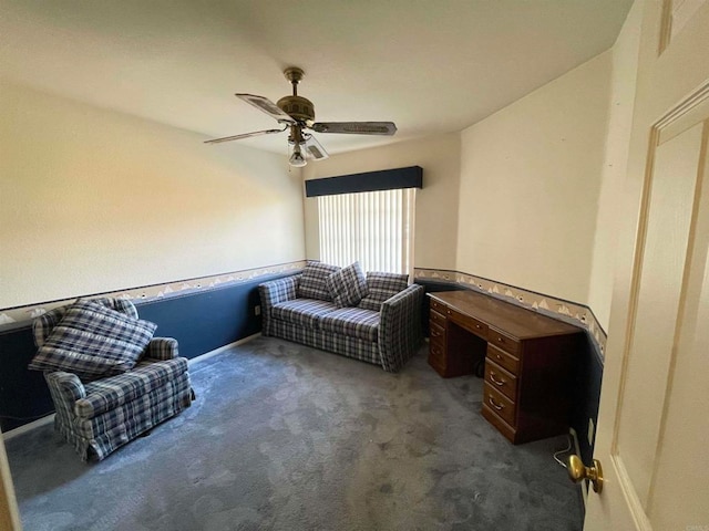 living area featuring dark carpet and ceiling fan