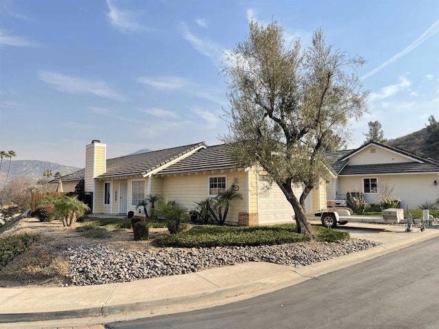 single story home featuring a mountain view and a garage