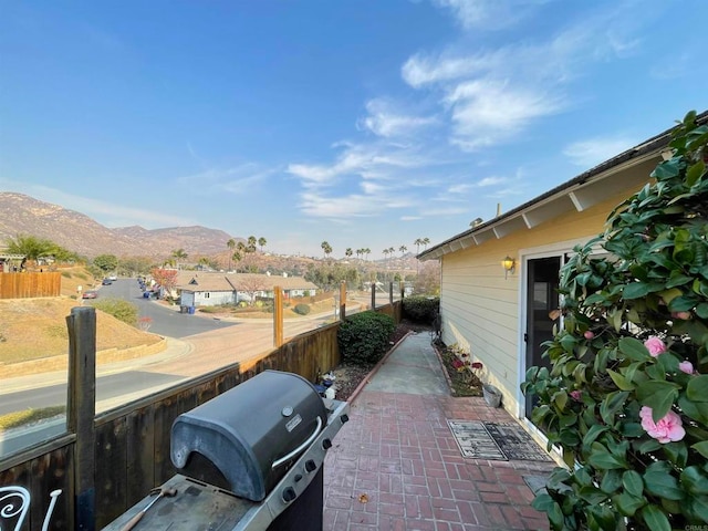 exterior space featuring a mountain view and a grill