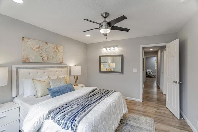 bedroom with light hardwood / wood-style flooring and ceiling fan