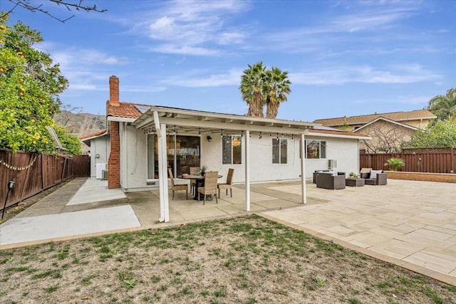 rear view of property with central AC, an outdoor living space, and a patio