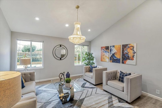 living room with lofted ceiling, light hardwood / wood-style floors, and a chandelier