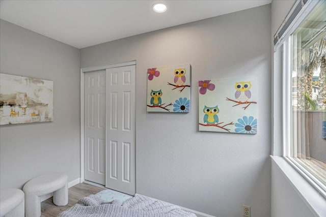 bedroom featuring a closet and light hardwood / wood-style flooring