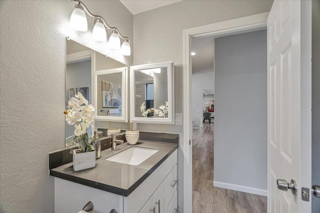 bathroom featuring vanity and hardwood / wood-style floors