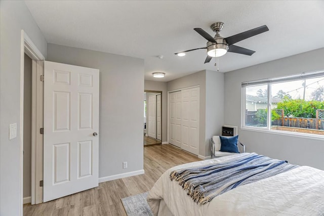 bedroom with light hardwood / wood-style floors, a closet, and ceiling fan