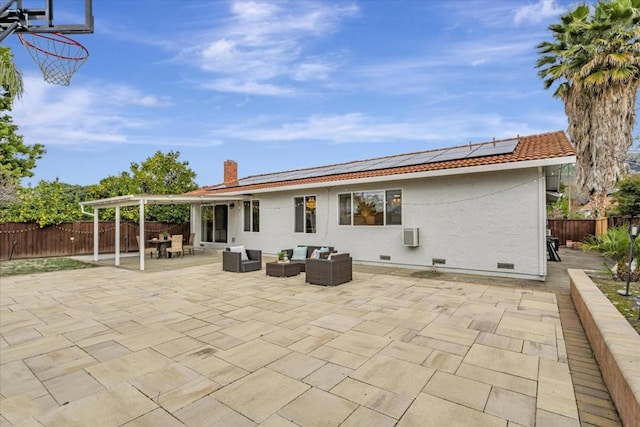 rear view of property with an outdoor hangout area, a patio area, and solar panels