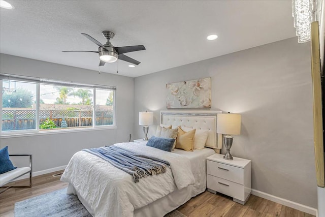 bedroom with ceiling fan and light wood-type flooring