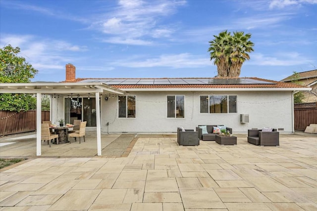 rear view of house featuring an outdoor hangout area, a patio, and solar panels