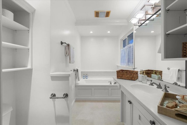 bathroom featuring crown molding, vanity, and a washtub