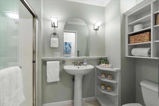 bathroom featuring sink, crown molding, and toilet