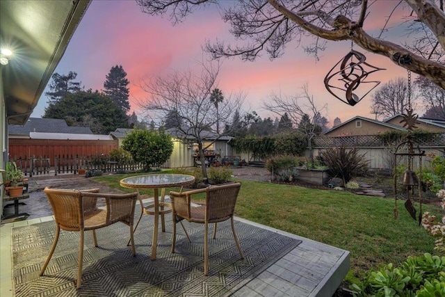 patio terrace at dusk with a lawn