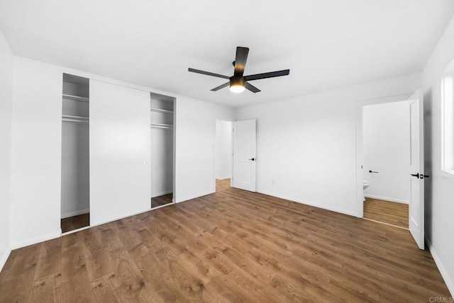 unfurnished bedroom featuring ceiling fan, hardwood / wood-style floors, and a closet