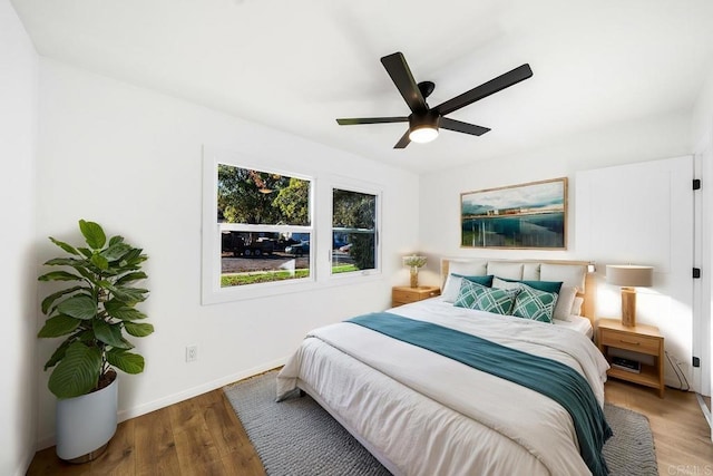 bedroom with wood-type flooring and ceiling fan