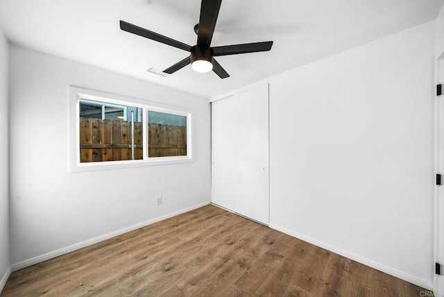 spare room with hardwood / wood-style flooring and ceiling fan