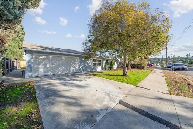 ranch-style house with a garage and a front yard