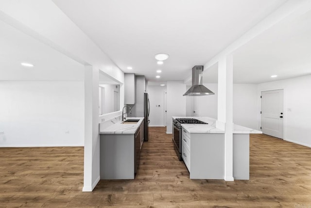 kitchen with island exhaust hood, sink, dark hardwood / wood-style floors, and gas stove