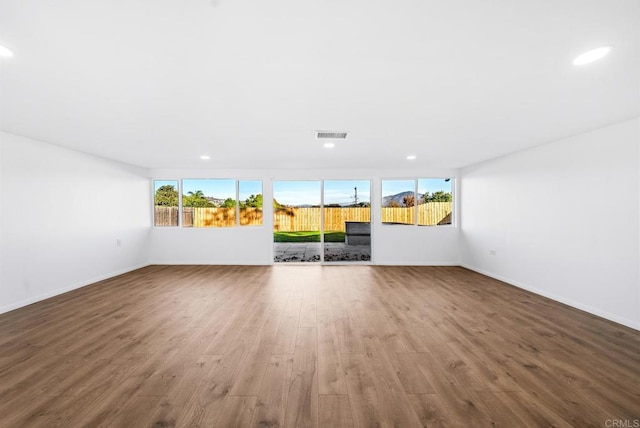 unfurnished living room featuring hardwood / wood-style floors